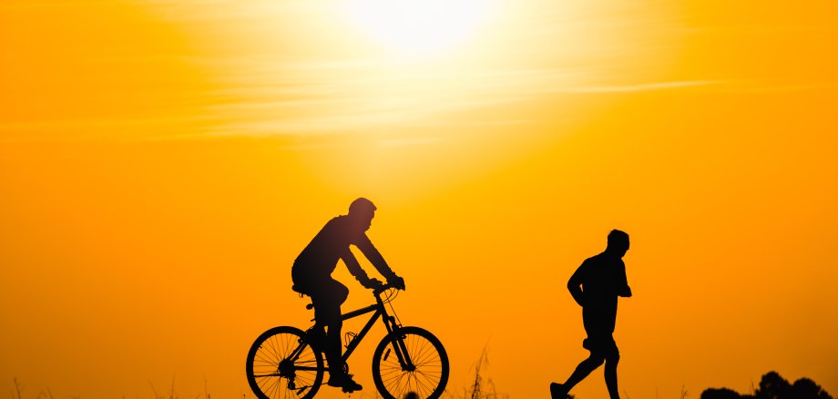 Silhouette,Man,Running,And,Cycling,In,Public,Park,For,Healthy