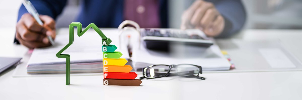Banner,Of,A,Businessman,Using,Calculator,Near,House,Model,With