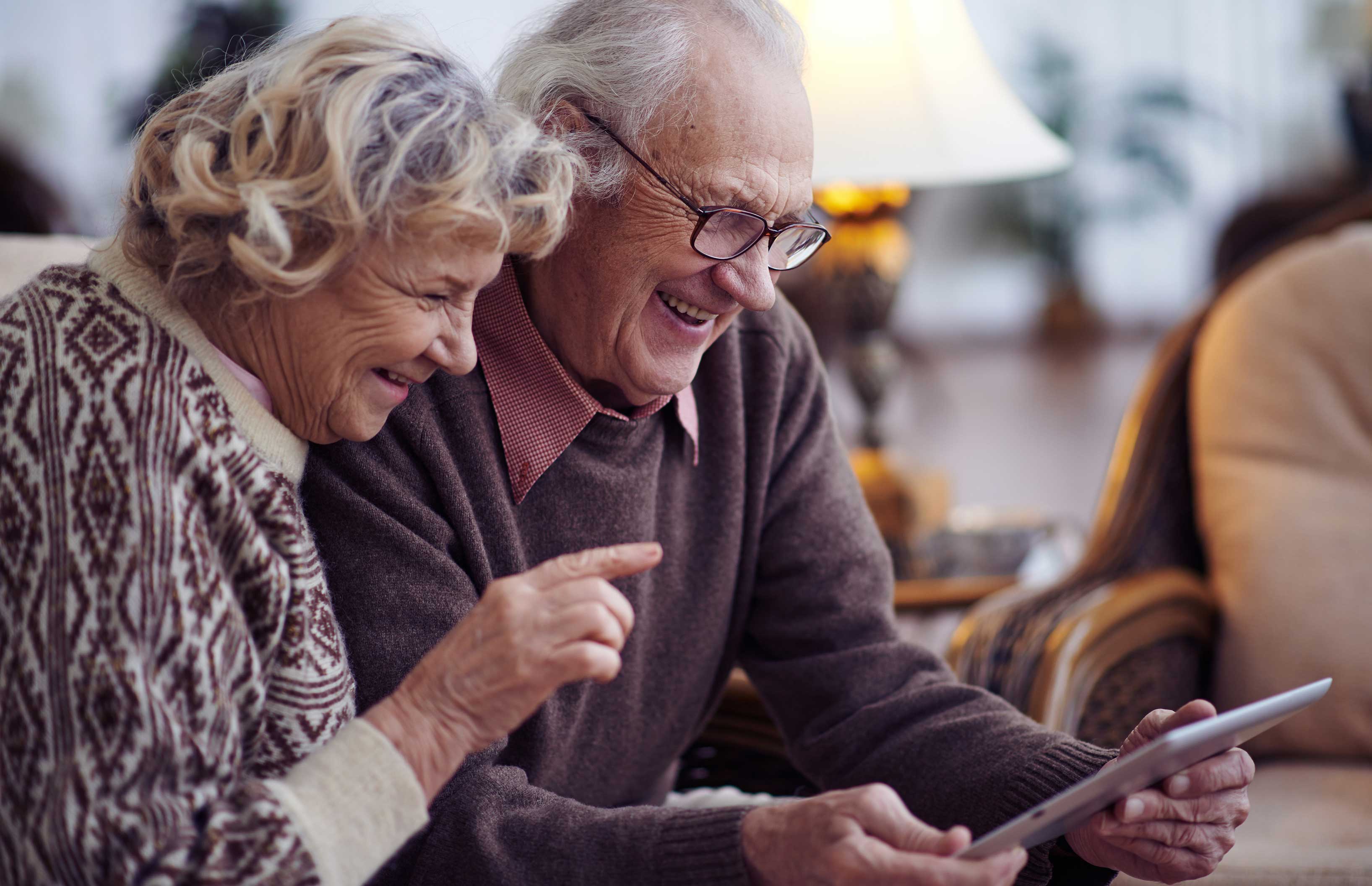 Elderly,Husband,And,Wife,Using,Digital,Tablet,At,Home Elderly,Husband,And,Wife,Using,Digital,Tablet,At,Home